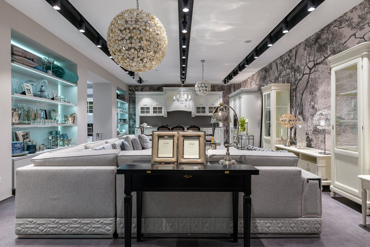Modern living room with gray sectional sofa, coffee table, and decorative elements.